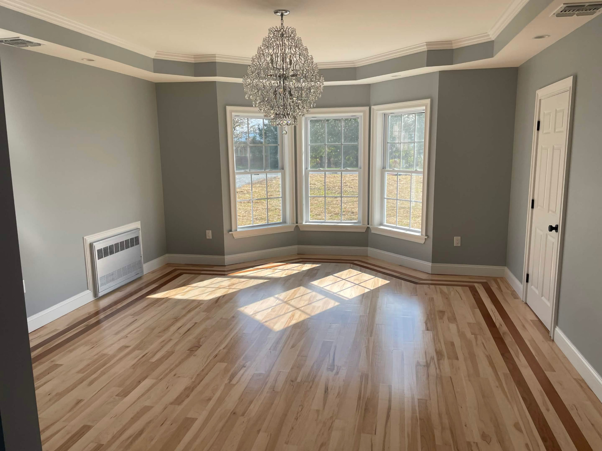 Finished dining room with crown molding and refinished hardwood