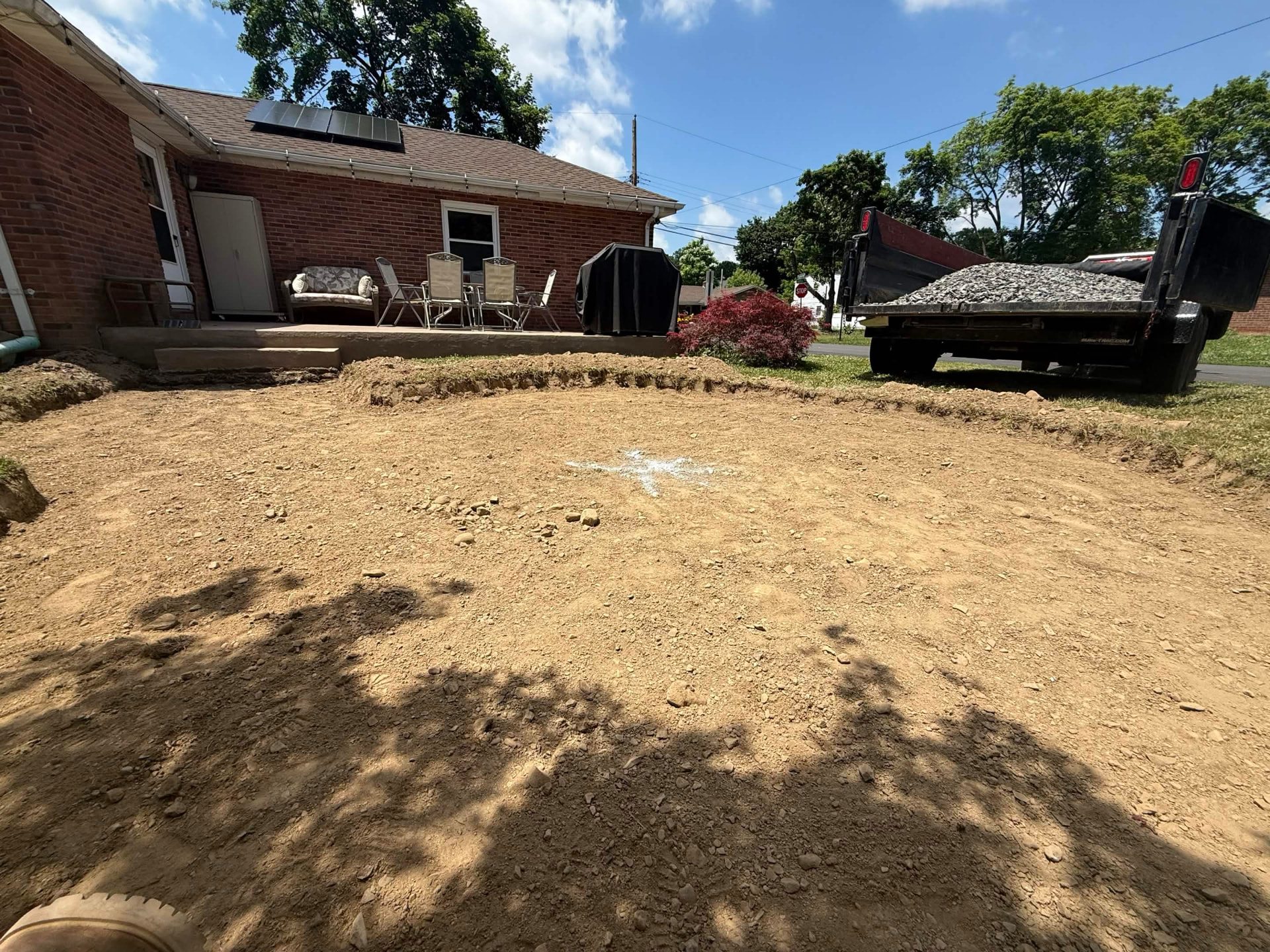Backyard excavated and graded for a new paver patio