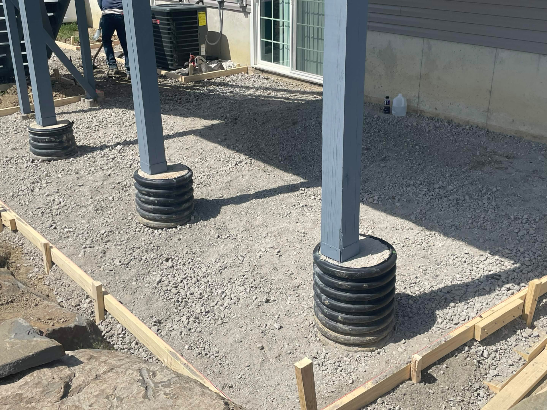 Crushed stone base prepared under a deck before pouring
