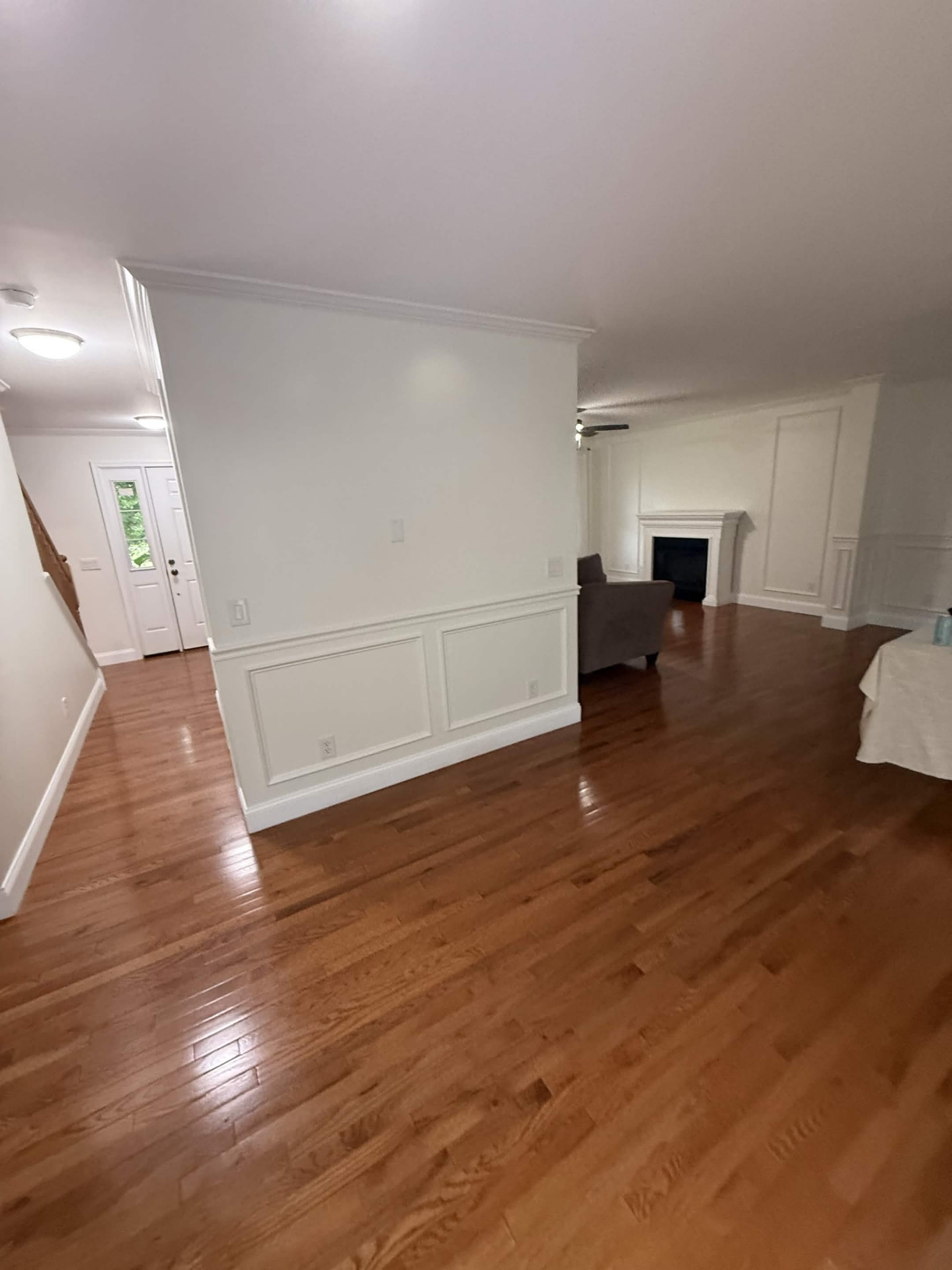 Hallway finished with white wainscoting and trim