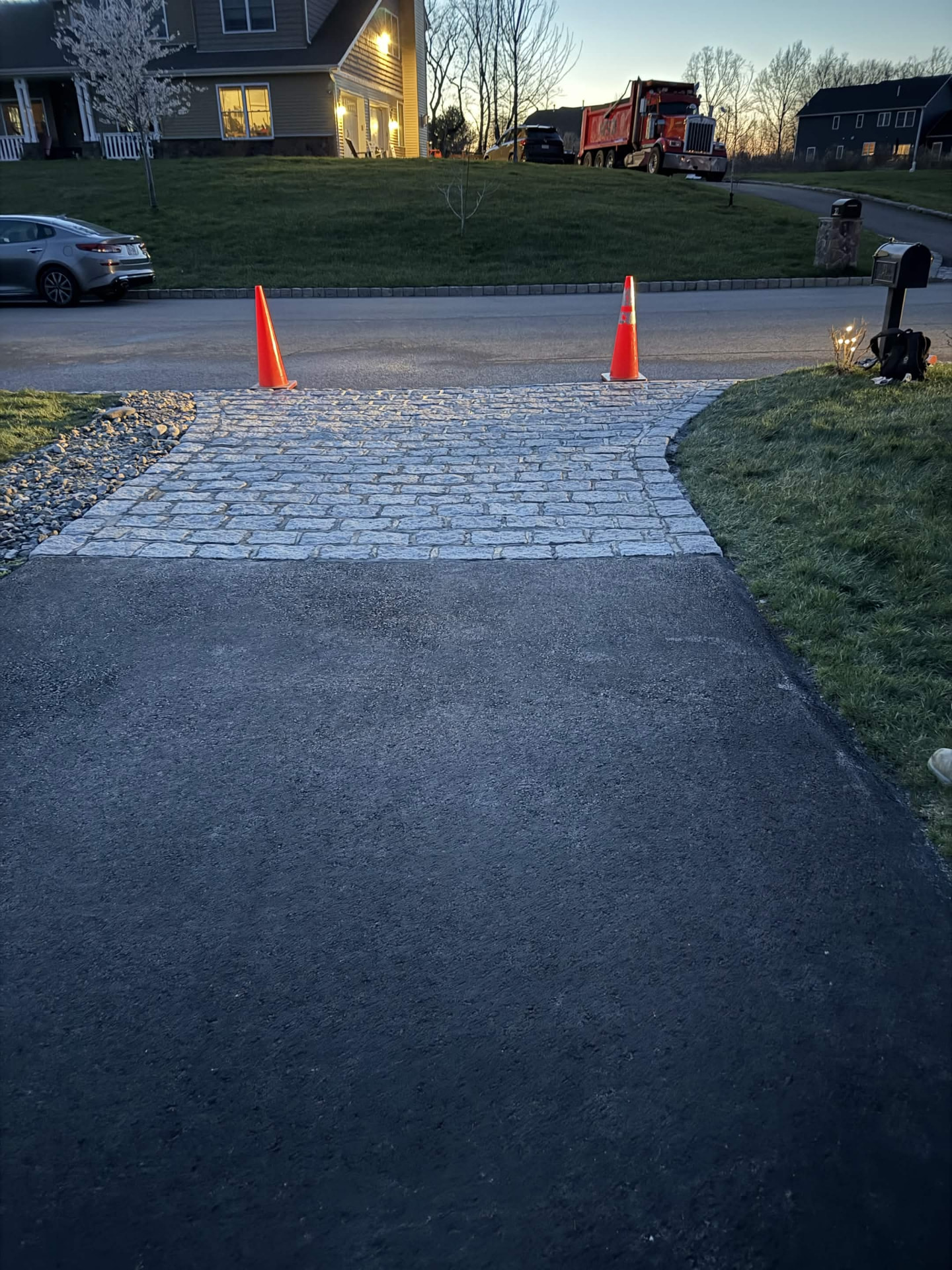 Cobblestone paver apron at a driveway entrance
